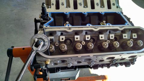 1985 Jeep CJ7 - A close-up view of an engine cylinder head being worked on with a torque wrench.