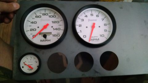 1985 Jeep CJ7 - Dashboard gauges including speedometer, tachometer, and fuel level indicator are mounted on a metal panel.