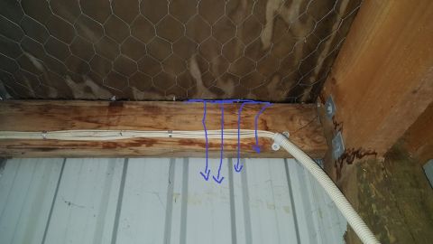 1969 Lincoln Continental - Water is dripping from a wooden beam, indicated by blue arrows, onto a metal wall below.