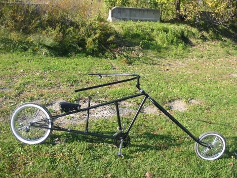 1981 Ford Bronco - A custom-built chopper bicycle with a unique frame design is displayed outdoors on a grassy lawn.