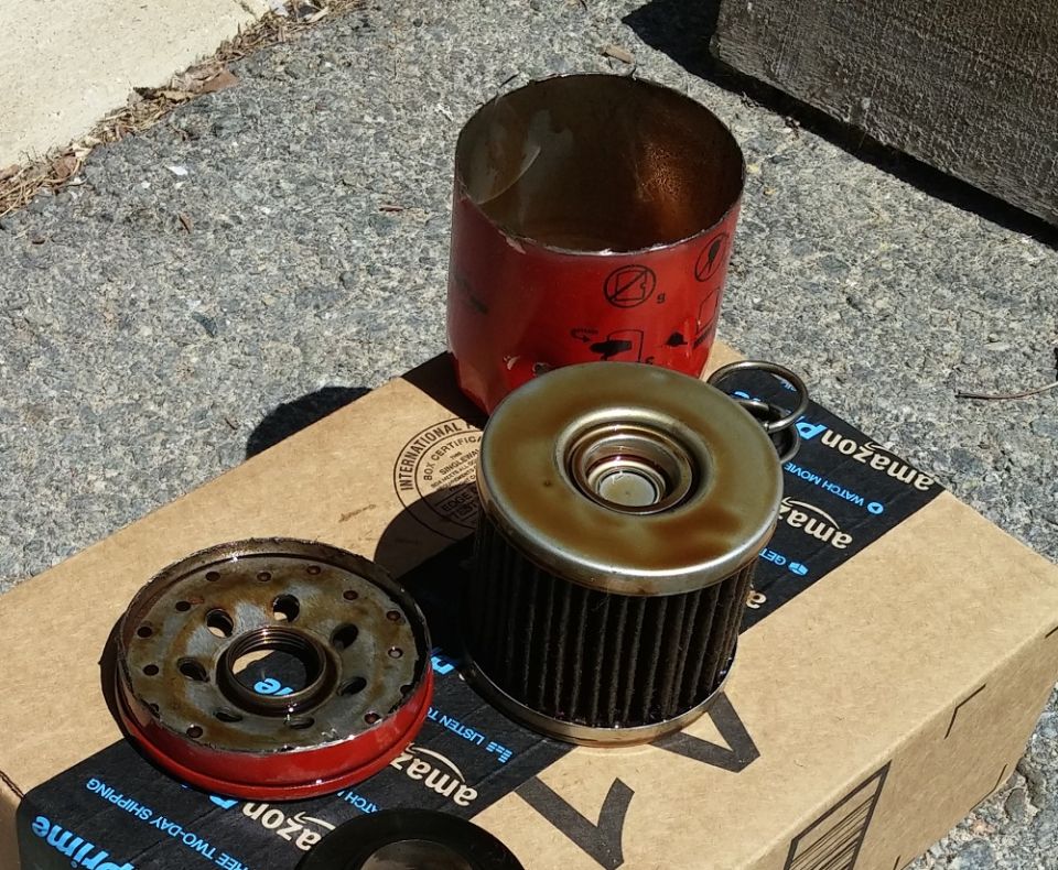 Used oil filter and casing on Amazon box