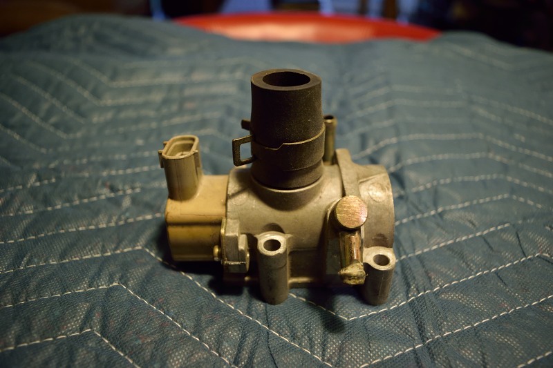 Automotive part with black hose on blue quilted surface