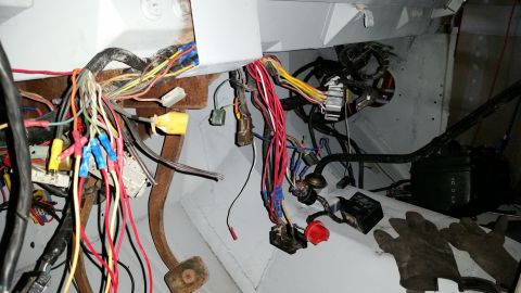 1979 Ford Bronco - The image shows a complex wiring harness with many colored wires, connectors, and electrical components, likely from the dashboard or engin…