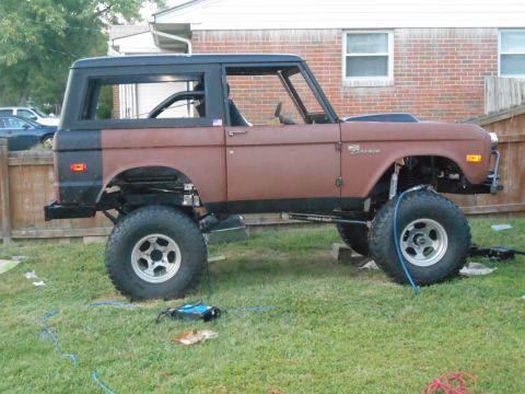 1972 Ford Bronco - This lifted 1972 Ford Bronco is shown in a side profile with a brown exterior and black top.