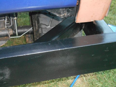 1972 Ford Bronco - Close-up view of the undercarriage and frame of a vehicle, showing suspension components and a portion of the body.