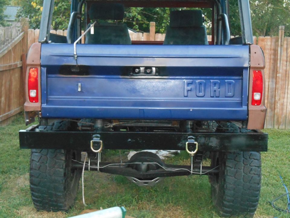 Rear view of blue 1972 Ford Bronco with black bumper and "FORD" tailgate