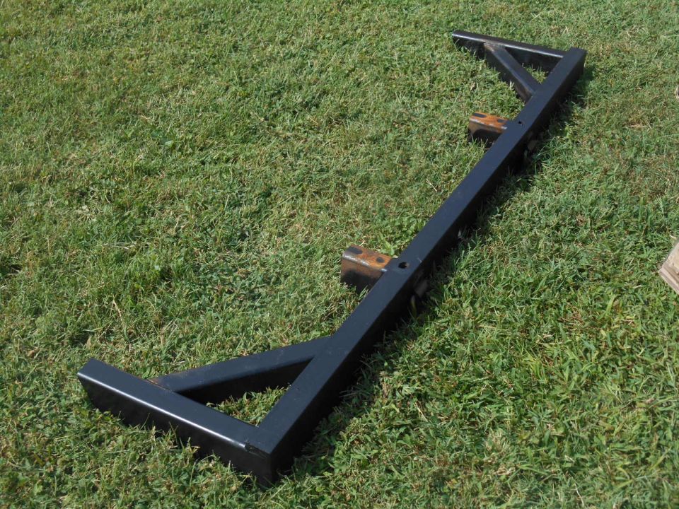 Black metal trailer hitch receiver on grass