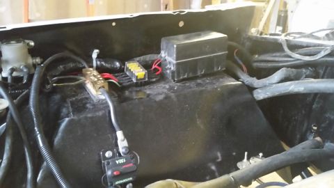 1979 Ford Bronco - A close-up view of the engine bay electrical components in a 1979 Ford Bronco, including a fuse box, a circuit breaker labeled "150A WATERP…