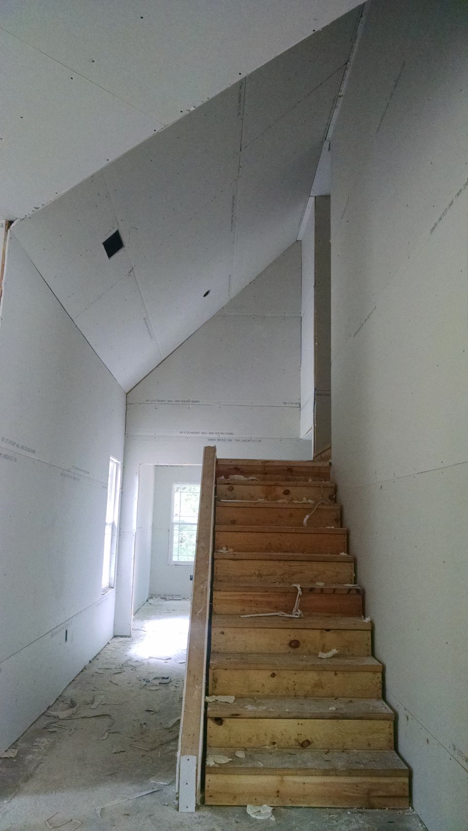The rest of the house was sheeted Saturday, but one spot was covered that shouldn't be.  And the electricians forgot to connect the fireplace, so a little more had to come down. Living room looking west through guest hall & bedroom 2.