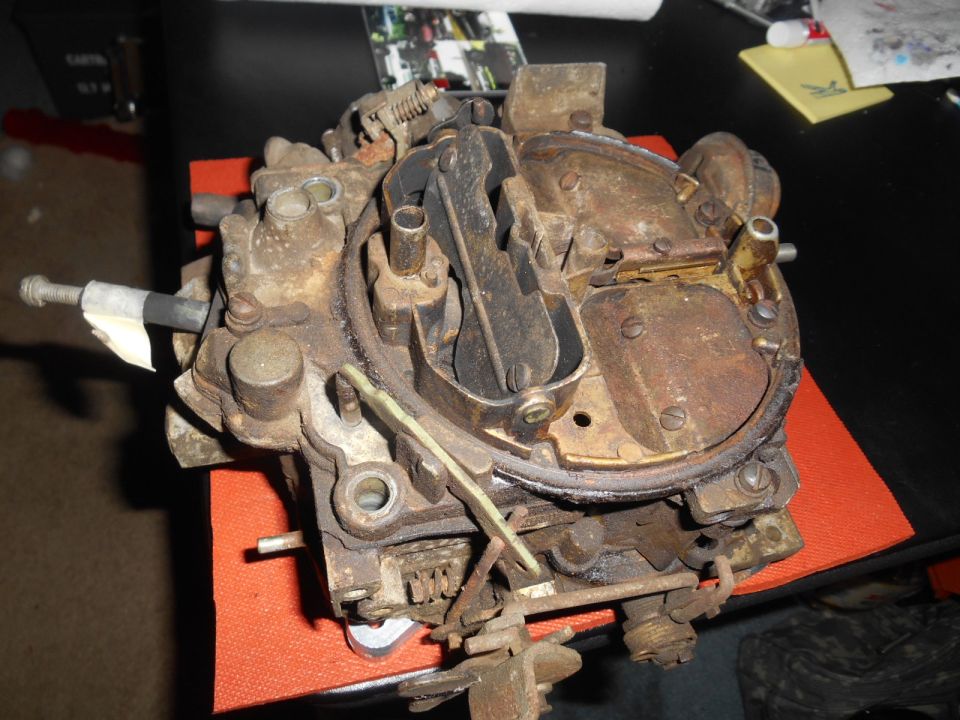 Close-up of a rusty carburetor.
