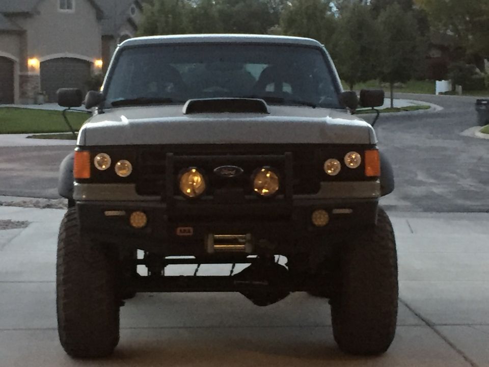 1988 Ford Bronco front view with aftermarket bumper, winch, and auxiliary lights