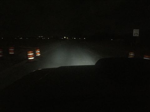 1988 Ford Bronco - Driving at night through a construction zone with traffic cones and a speed limit sign.