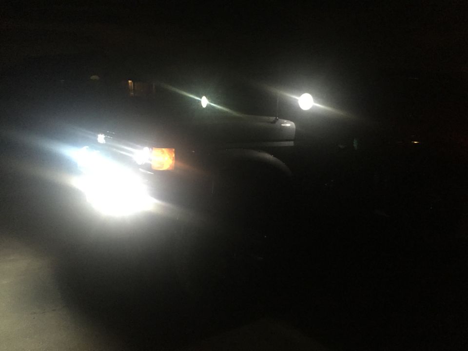 Truck headlights at night, front view. Amber turn signal visible