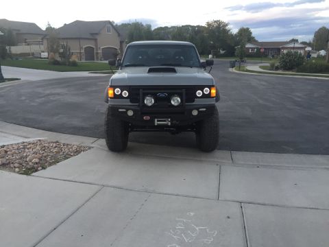 1988 Ford Bronco - Front view of a modified 1988 Ford Bronco parked on a suburban street.