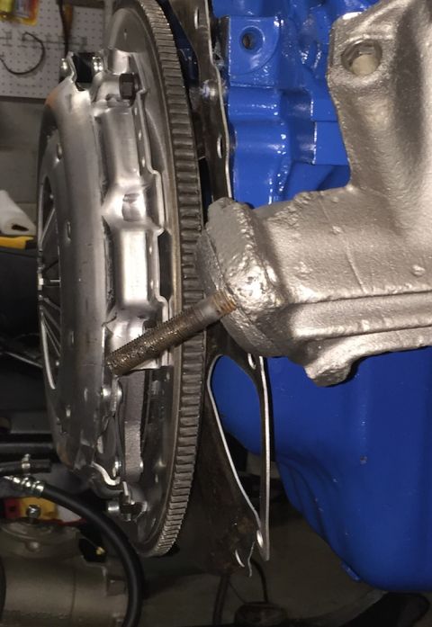 1978 Ford Bronco - Close-up view of a clutch and flywheel assembly attached to a blue engine block.