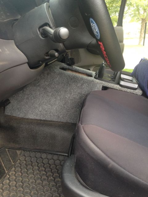 2001 Ford Ranger - The interior of a 2001 Ford Ranger is visible, including the steering wheel, dashboard, and seating area.