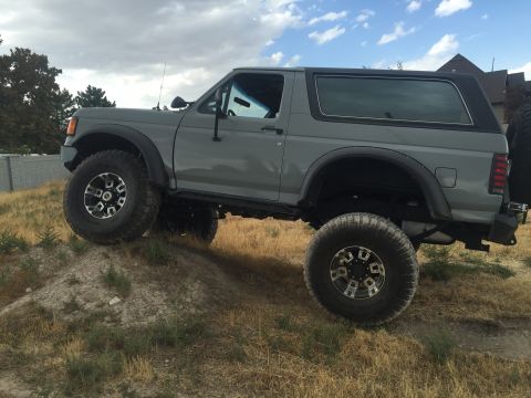 1988 Ford Bronco - This lifted 1988 Ford Bronco is shown off-road, demonstrating its off-road capabilities.