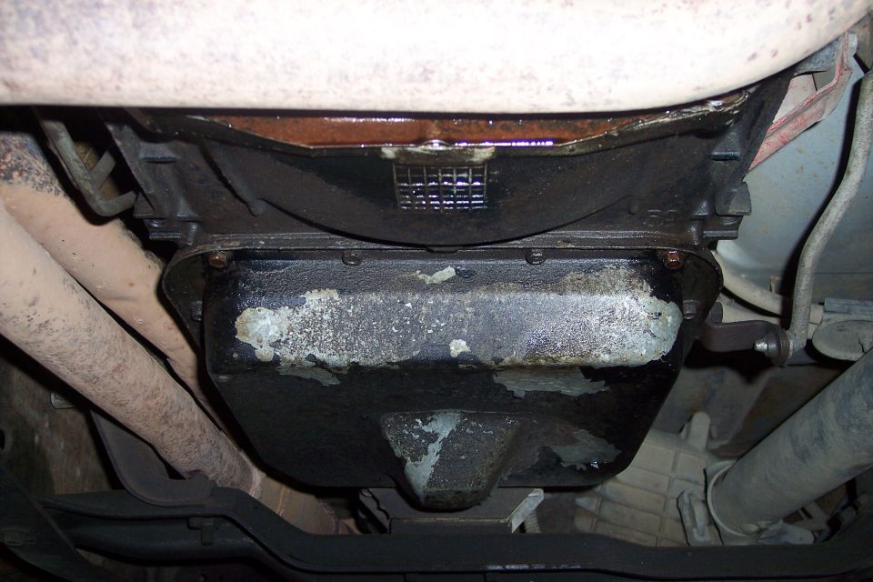 underside of vehicle showing oil pan and exhaust pipes