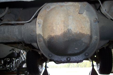 1990 Ford Bronco - Underside view of a vehicle's rear differential showing signs of an oil leak.