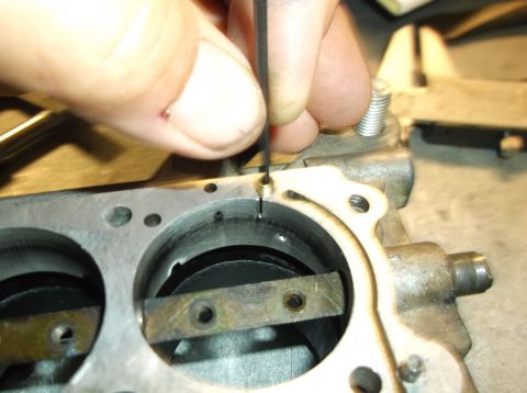 1979 Ford Ranchero - Hand adjusting a screw on a carburetor component, likely during maintenance or repair.