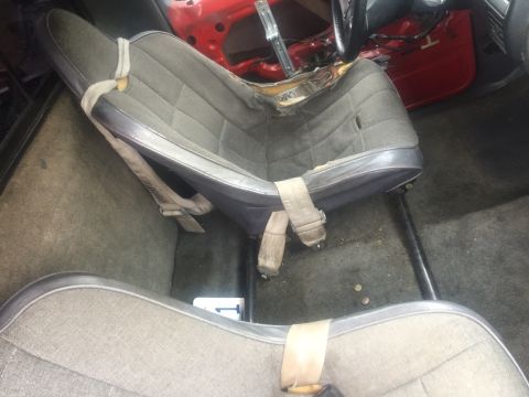 1986 Ford Bronco - Interior view of a vehicle's seats, with visible wear and tear on the upholstery.