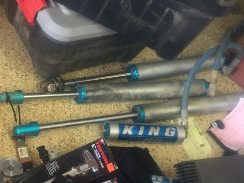 1986 Ford Bronco - Several King Off Road shocks are visible alongside a caliper and other tools.