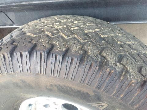 1986 Ford Bronco - A close-up view of a tire tread, showing wear and dirt, with a website watermark at the bottom.