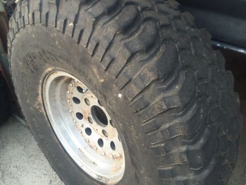 1986 Ford Bronco - A close-up view of a tire and wheel assembly, with visible tread detail.