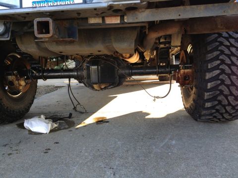 1995 Ford Bronco - Close-up view of the rear axle and suspension system of a modified truck.