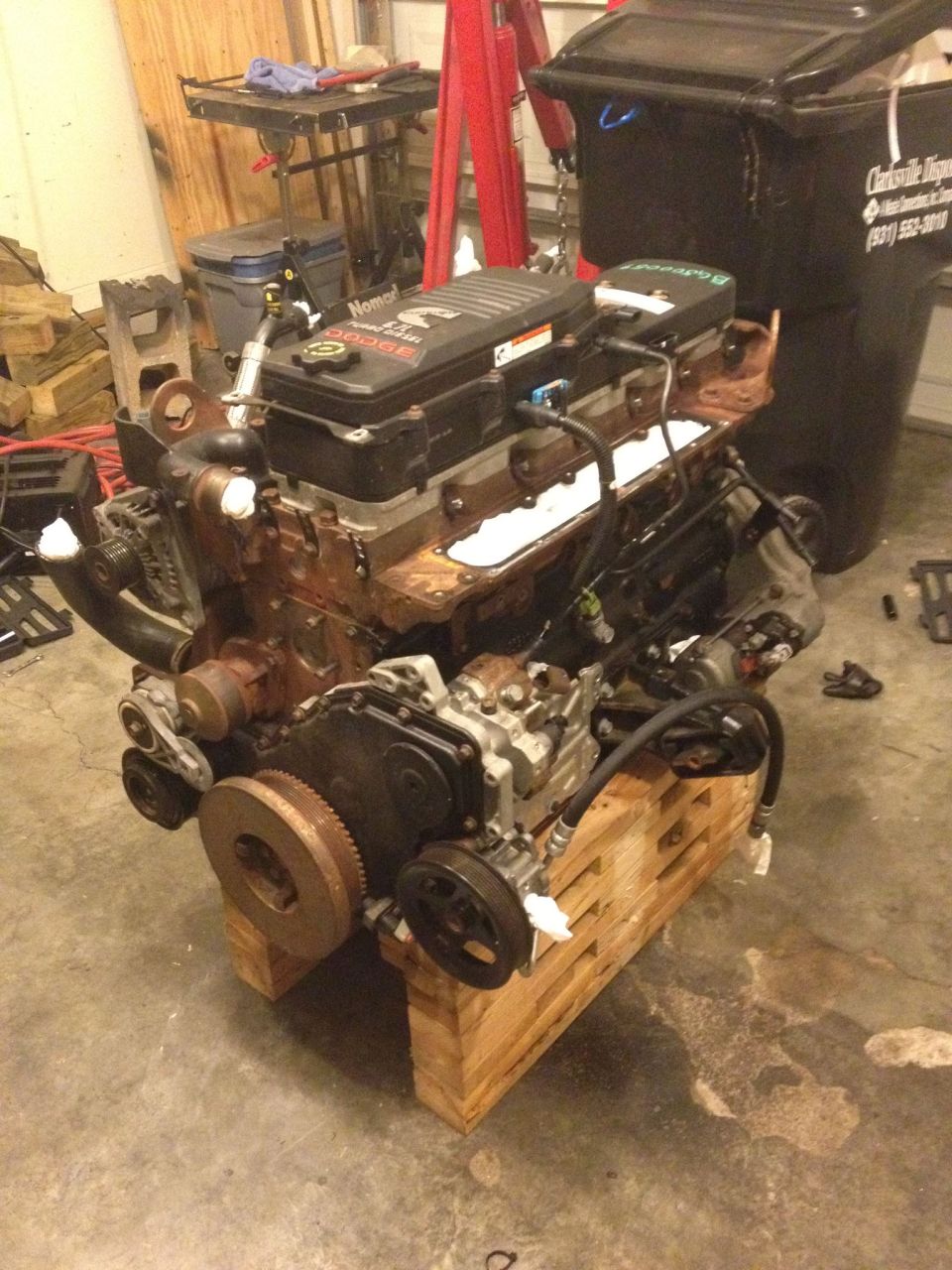 Cummins 5.9L diesel engine on wooden blocks in a garage