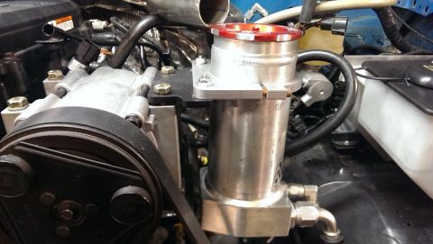 1995 Ford Bronco - Custom engine component with a prominent aluminum reservoir and visible branding from Supermotors.