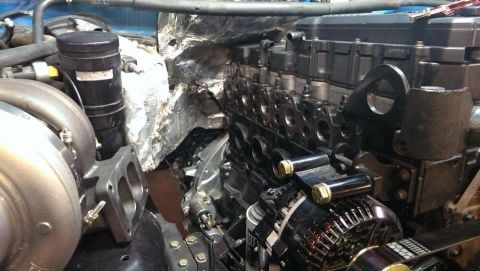 1995 Ford Bronco - Close-up view of a diesel engine with a turbocharger and exhaust manifold installed.