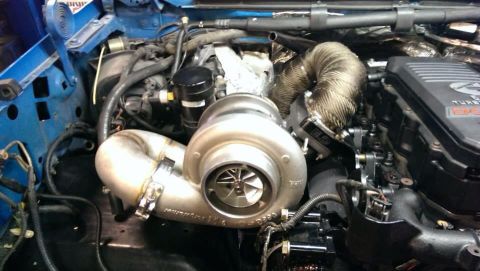 1995 Ford Bronco - Close-up view of an engine bay, highlighting a large turbocharger and associated plumbing.