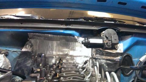 1995 Ford Bronco - Close-up of a windshield wiper motor assembly, likely during installation or repair.