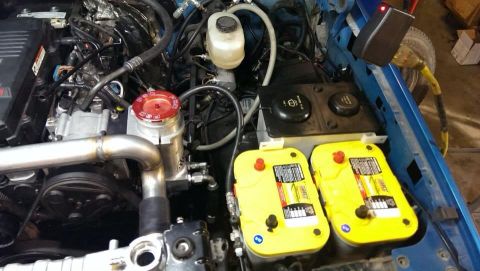 1995 Ford Bronco - The engine bay shows a custom setup with dual batteries and modified intake plumbing.