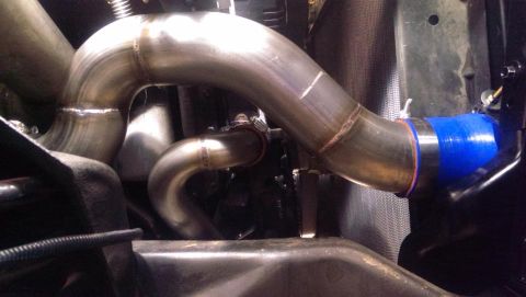 1995 Ford Bronco - Custom exhaust piping with a blue silicone coupler is visible in this close-up shot.