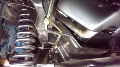 1995 Ford Bronco - The underside of a vehicle shows suspension components and exhaust piping.