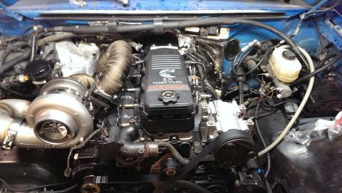 1995 Ford Bronco - The engine bay shows a Cummins 6.7L turbo diesel, not a 1995 Ford Bronco.