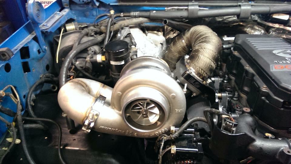 Engine with large turbocharger and exhaust manifold