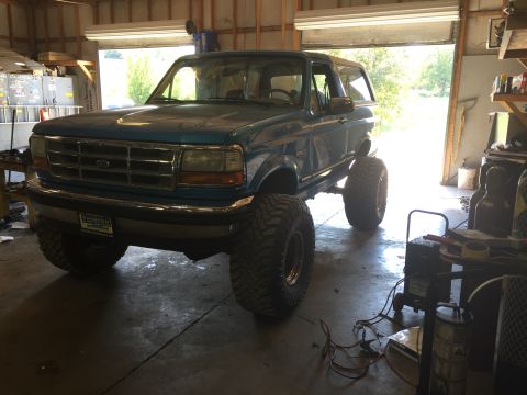 1995 Ford Bronco - This 1995 Ford Bronco is lifted and parked inside a garage.