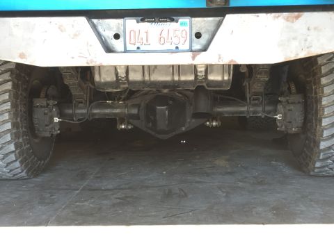 1995 Ford Bronco - Close-up view of a truck's rear axle and suspension system, showing the differential and tires.