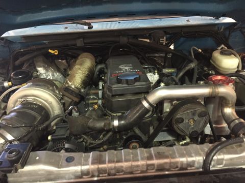 1995 Ford Bronco - Engine bay view of a Cummins 6.7L turbo diesel with aftermarket turbo and intercooler.