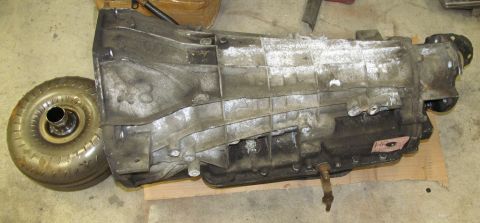 1995 Ford Bronco - A used automatic transmission and its torque converter are shown, likely removed from a vehicle.