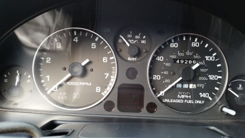 1991 Mazda Miata - Close-up of a car's dashboard gauges, including the speedometer and tachometer.