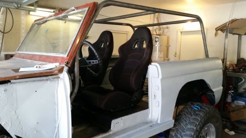 1979 Ford Bronco - A custom roll cage and racing seats have been installed in the interior of a classic Ford Bronco, which appears to be undergoing restoratio…