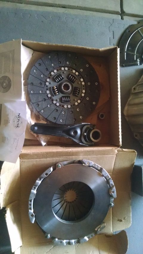 1985 Jeep CJ7 - A Novak clutch disc and pressure plate are shown in cardboard boxes. A clutch fork is also visible in the upper box.