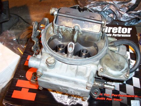 1994 Ford Bronco - A Holley carburetor sits on a box from Supermotors.net, a website for performance parts.