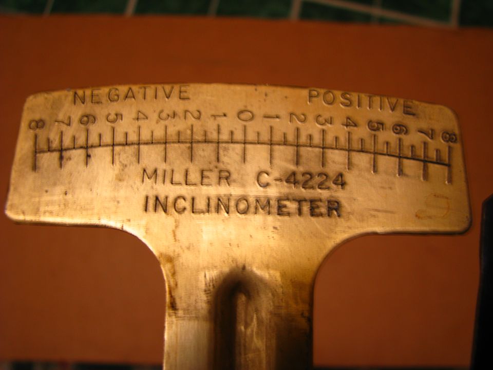 Brass Miller C-4224 inclinometer with a negative to positive scale.