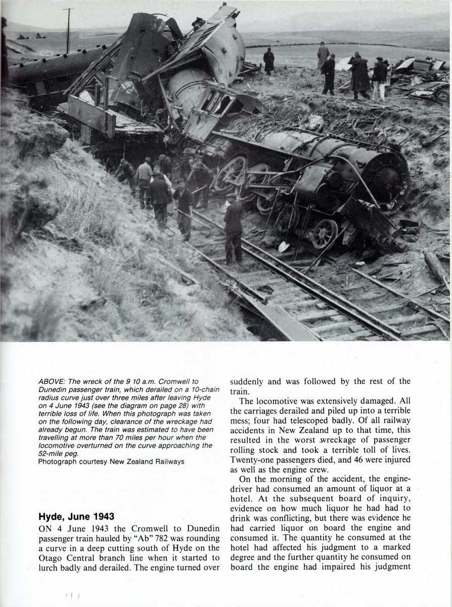 Wreckage of a train derailment with a damaged locomotive and carriages.