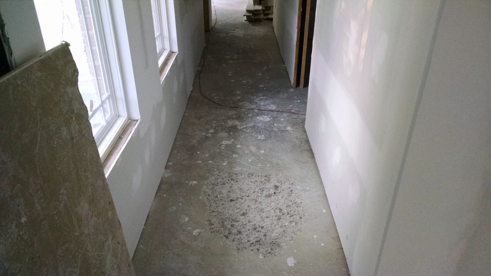 Master hall looking northwest to living room.

I spent ~6hrs today sweeping & leaf-blowing the house out.  The trash can was almost too heavy for me to lift into the dumpster.

The rough area used to be a lump - now it's low enough for the tile man to float across it.